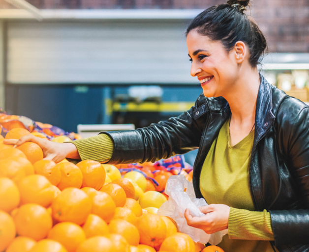 Woman picking selecting oranges